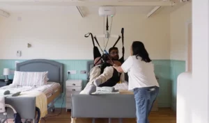 Person Being Hoisted Using Ceiling Hoist With Slings